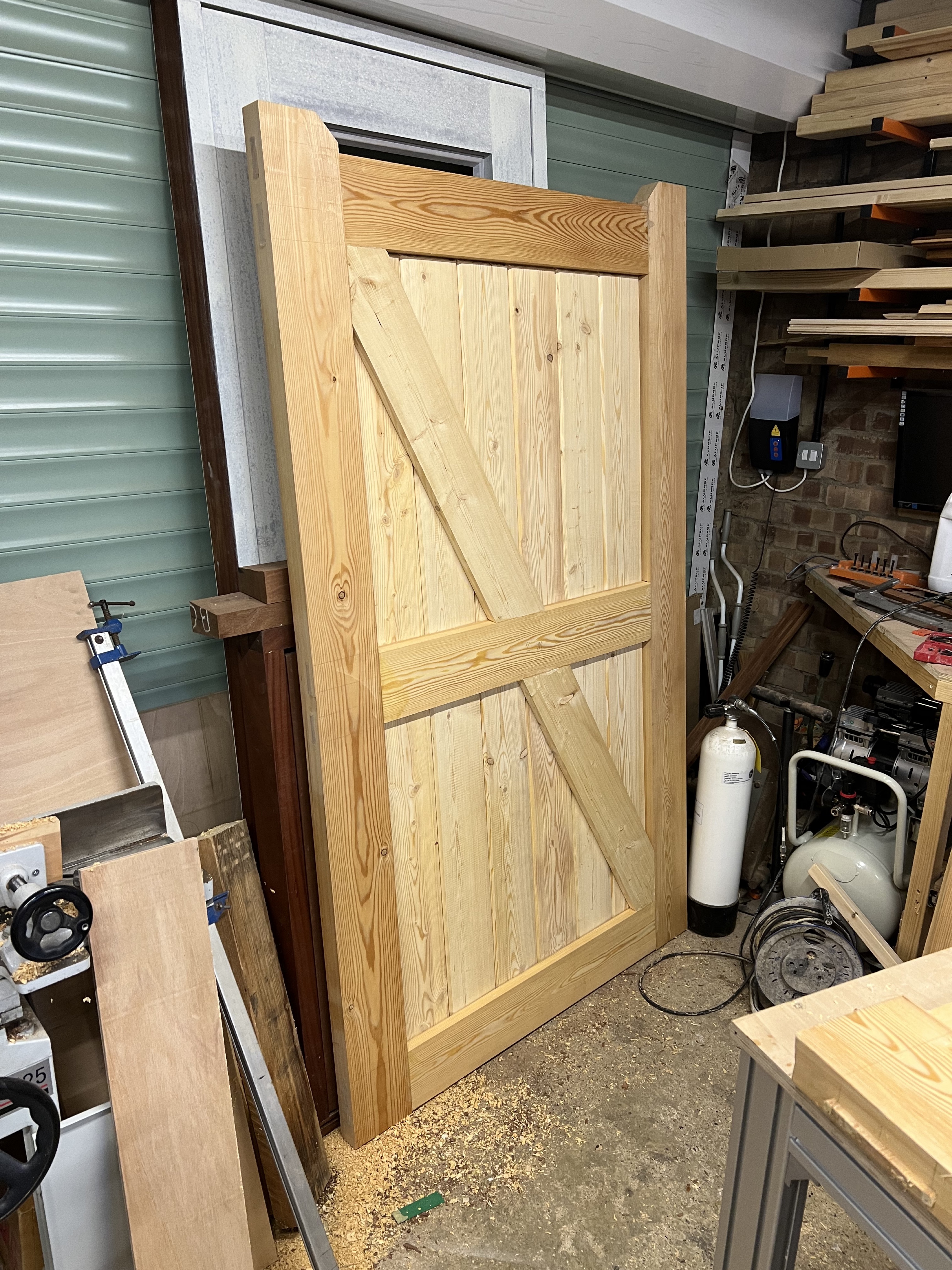 Custom timber door with diagonal bracing