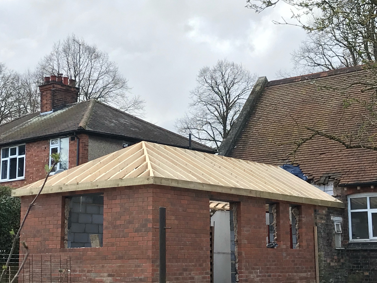 Brick extension with new pitched roof framework